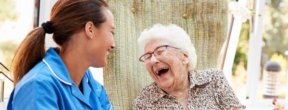 Carer-laughing-with-elderly-lady