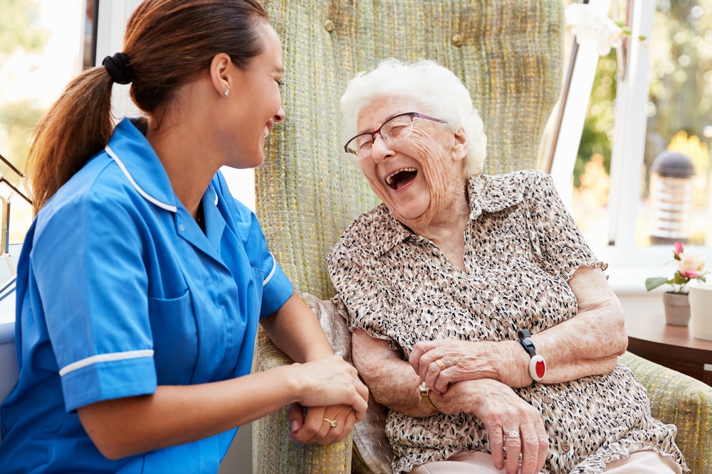 Carer-laughing-with-elderly-lady