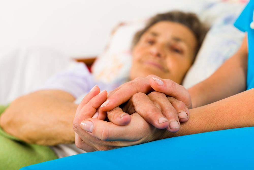 carer-holding-patients-hands