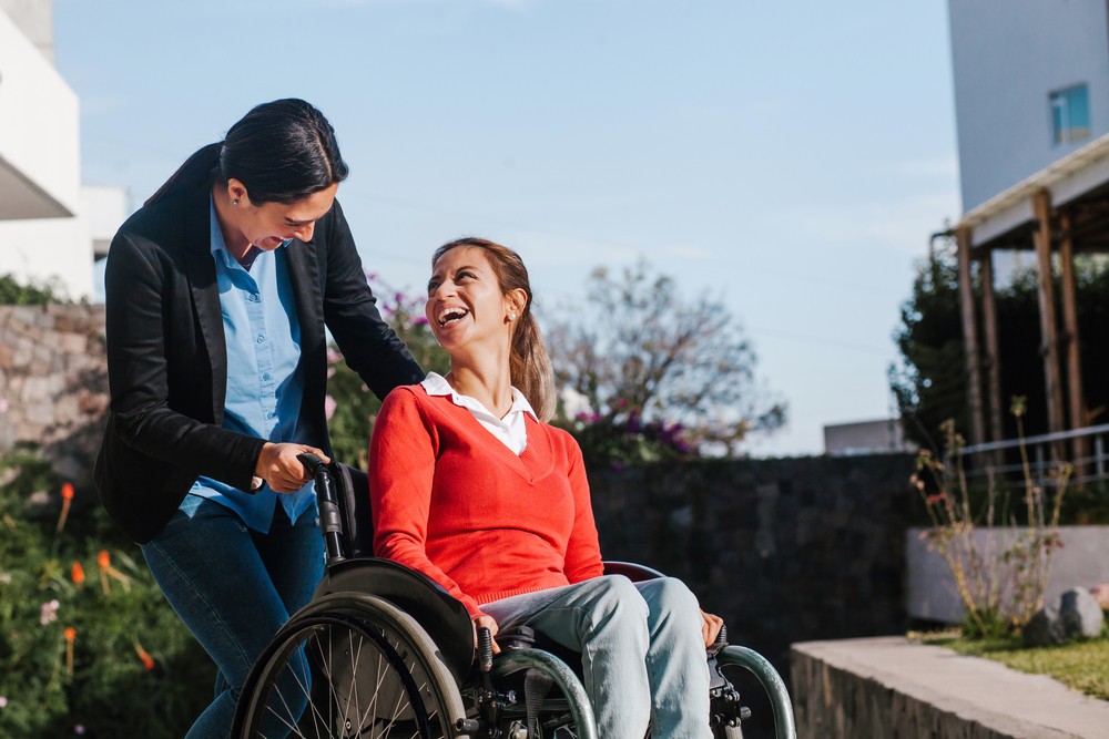carer-laughing-with-lady-in-a-wheelchair