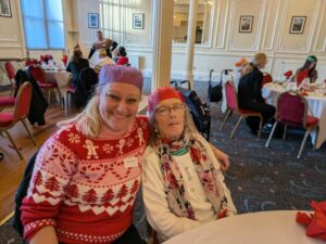 Carers and clients in festive jumpers at the Continued Care Christmas Luncheon 2025 in Harrogate