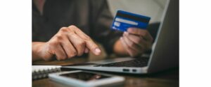 stopping scams can be difficult picture of hand holding credit card and laptop